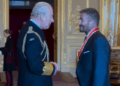 King Charles speaks to Sir David Beckham after knighting him at Windsor Castle