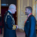 King Charles speaks to Sir David Beckham after knighting him at Windsor Castle