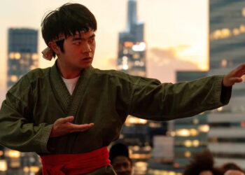 Ben Wang as Li Fong practicing his movies on a rooftop in Karate Kid: Legends