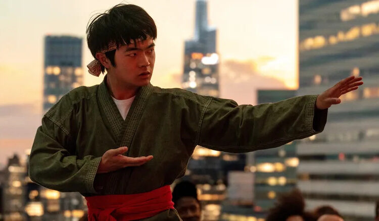 Ben Wang as Li Fong practicing his movies on a rooftop in Karate Kid: Legends
