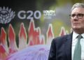 Sir Keir Starmer spoke to reporters on his way to the G20 in South Africa. Pic: Reuters