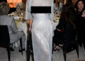 Sydney Sweeney poses on the red carpet wearing a silver dress.