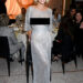 Sydney Sweeney poses on the red carpet wearing a silver dress.