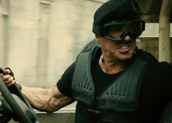 Barney Ross in a vehicle and goggles in The Expendables 2