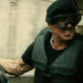 Barney Ross in a vehicle and goggles in The Expendables 2