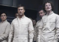 Glen Powell and others in white paint suits