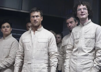 Glen Powell and others in white paint suits