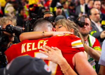 Kansas City Chiefs tight end Travis Kelce (87) celebrates with fiancee Taylor Swift.© Mark J&period; Rebilas-Imagn Images