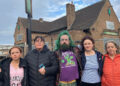 Five people standing in front of a derelict pub, the Lincoln Imp. There are three women, one man and a girl.