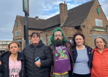 Five people standing in front of a derelict pub, the Lincoln Imp. There are three women, one man and a girl.