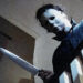 Michael Myers leaning over the stair railing in Halloween (1978)