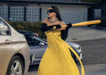 Kim Kardashian as Allura Grant hitting a car with a baseball bat while wearing a formal gown on All's Fair