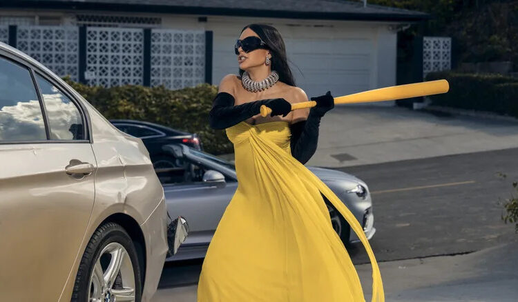 Kim Kardashian as Allura Grant hitting a car with a baseball bat while wearing a formal gown on All's Fair