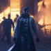 Lee Pace as Evan McCone wearing a mask and trench coat standing in front of a burning building in The Running Man
