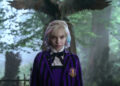 Wednesday (as Enid) stands near a grave in Jericho in Wednesday