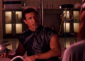Sylvester Stallone as John Spartan holding a metallic object in Demolition Man