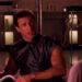Sylvester Stallone as John Spartan holding a metallic object in Demolition Man