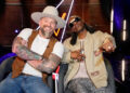 Zac Brown and Snoop Dogg posing and smiling together on The Voice Season 28 Episode 10.