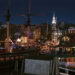 A shot of the city of Newport lit up at night with a sail boat in the foreground in A Newport Christmas.