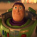 Buzz Lightyear smiles solemnly in the glow of carnival lights in Toy Story 4.