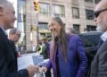 The Tragically Hip's Rob Baker signs a fan's poster after a public sing-along with Choir! Choir! Choir! at the Toronto International Film Festival, in Toronto, on Thursday Sept. 5, 2024. THE CANADIAN PRESS/Paige Taylor White