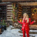 trisha yearwood stands in front of a snowy log cabin on set of christmas time is here music video