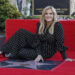 Country music singer Trisha Yearwood sits next to her star during an unveiling ceremony honoring her with the 2,805th star on the Hollywood Walk of Fame in Los Angeles in March. File Photo by Jim Ruymen/UPI