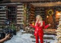 trisha yearwood stands in front of a snowy log cabin on set of christmas time is here music video