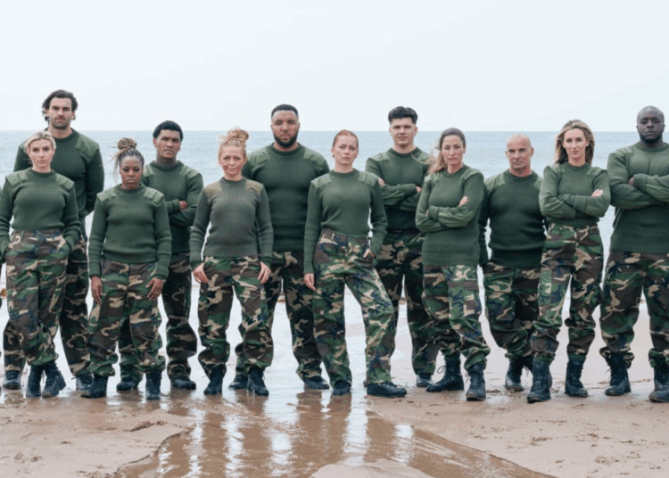 They stand on a beach, wearing green and camouflage military-style garb