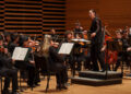 Chelsea Gallo conducting the orchestra.