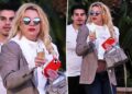 Unrecognizable Britney Spears leaves wine bar with champagne flute