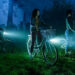 Arian S. Cartaya as Rich, Clara Stack as Lilly Bainbridge, and Amanda Christine as Ronnie Grogan riding bikes in a cemetery at night in It: Welcome to Derry