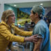 Pluribus Carol grabbing Dr. Nguyen's arms in hospital cafe
