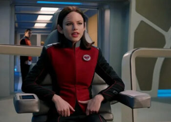 Lieutenant Alara Kitan sitting in the captain's chair on The Orville