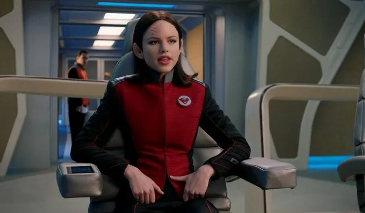 Lieutenant Alara Kitan sitting in the captain's chair on The Orville