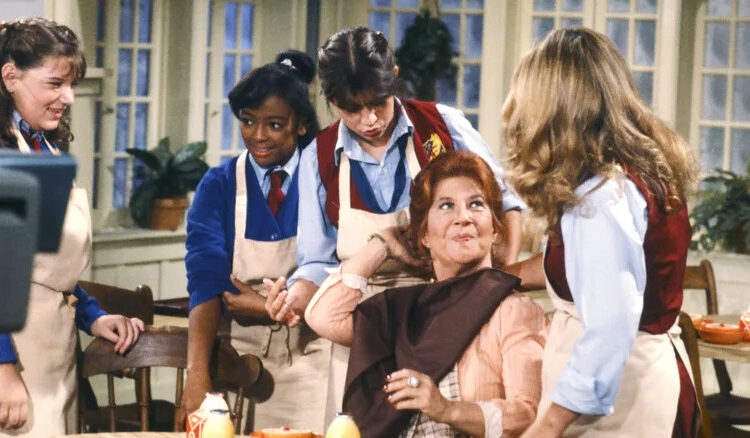 Mrs. Garrett, sitting, with the four main girls standing around her
