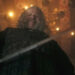 Peter Mullan as Vesemir looking down at the camera with his sword in The Witcher season 4