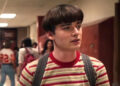 Noah Schnapp's Will Byers stands in a school hallway in Stranger Things