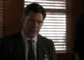 Thomas Gibson's Aaron Hotchner sits in an office in Criminal Minds