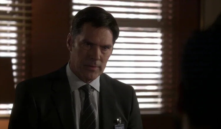 Thomas Gibson's Aaron Hotchner sits in an office in Criminal Minds