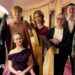 Seven members of Scran stand in a group holding their musical instruments. They are aged between 13 and 17.
