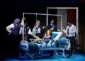 Leslie Rodriguez Kritzer, center, with the cast of the musical "Working Girl."