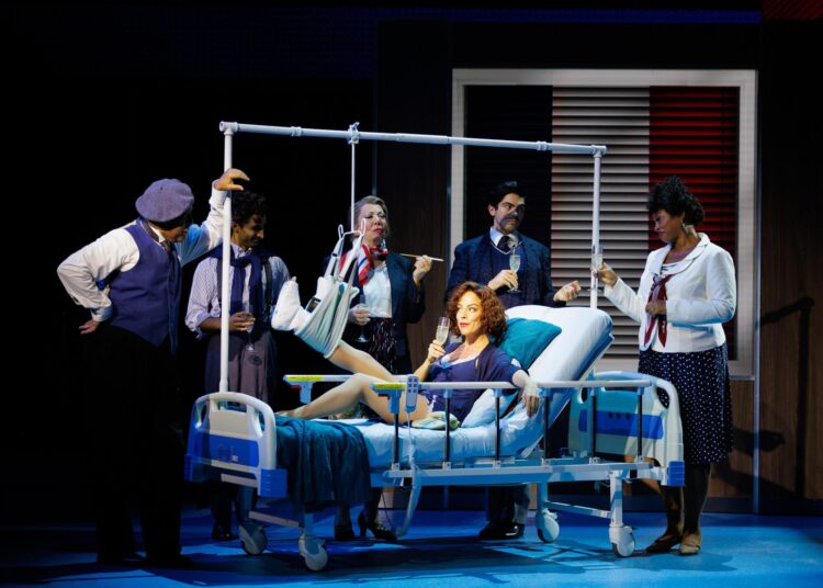 Leslie Rodriguez Kritzer, center, with the cast of the musical "Working Girl."