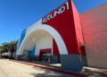Image shows exterior of Round1 Bowling & Arcade featuring an arched facade.
