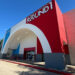 Image shows exterior of Round1 Bowling & Arcade featuring an arched facade.