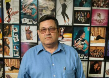 Abraham Quintanilla Jr., father of deceased Tejano singer Selena, stands in front of a wall displaying photos of his daughter at "Q" Productions in Corpus Christi, Texas, Thursday, March 17, 2005. (AP Photo/Paul Iverson)