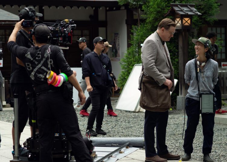 Brendan Fraser, left, on the set of "Rental Family" with director Hikari.