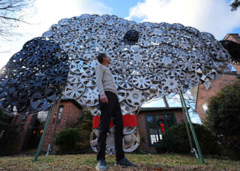 Baltimore cyclist finds joy in collecting lost hubcaps and stringing them into art