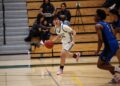 Viking junior Aiden Ong pushes the ball up the court against two defenders during a home game in front of an energetic crowd. According Ong, playing at home provides a valuable boost heading into the season. "It means there’s going to be extra energy and momentum," Ong said. "With a loud home crowd, the opponents will feel the pressure, and our team can use that energy and channel it into the game."