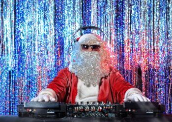 DJ Santa Claus mixing up some Christmas cheer. Disco lights in the background.